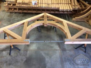 Timber truss with steel bottom chord turnbuckle. Adding steel can increase the structural integrity and allow for curves that wow.