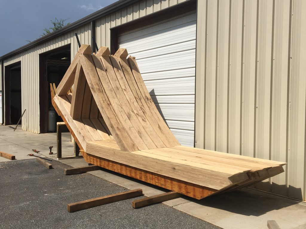 White Oak heavy timber trusses are split in half and waiting to be